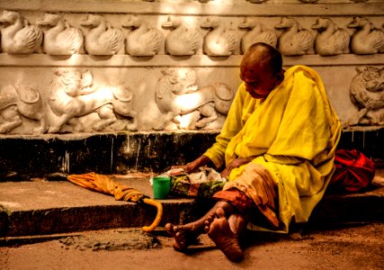 Man In Yellow Sitting Outside During Daytime