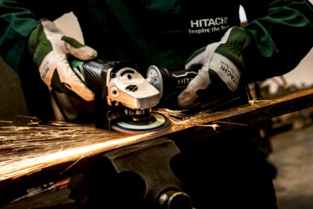 Person Holding Black And Gray Hitachi Angle Grinder photo