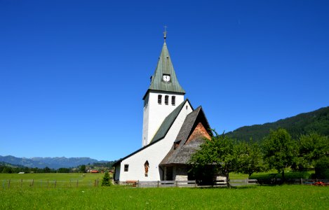 White And Gray Painted Chapel Near Green Open Field During Daytime photo
