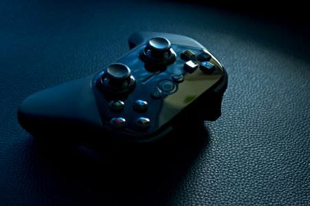 Black Wireless Game Controller On Black Leather