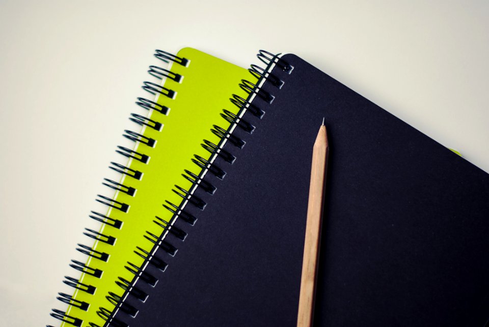 Brown Pencil On Black And Green Book