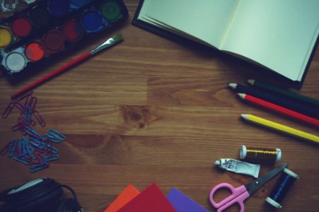 Red Yellow Blue Color Pencil Beside White Printer Paper On Brown Wood