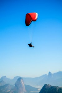 Red White Parachute On Top Of Mountains During Daytime photo