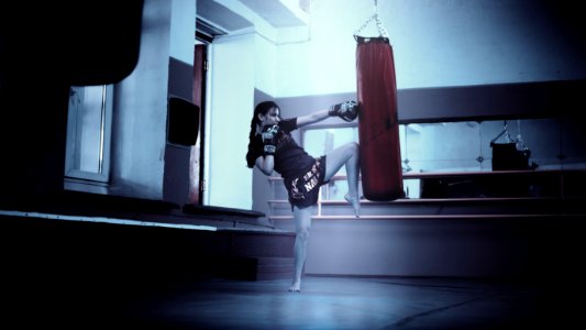 Woman Punching Red Heavy Bag