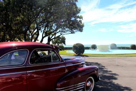 Red Classic Car Parked Near Tree During Daytime