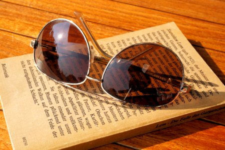 Silver Steel Framed Aviator Sunglasses On Top Of Book During Daytime photo