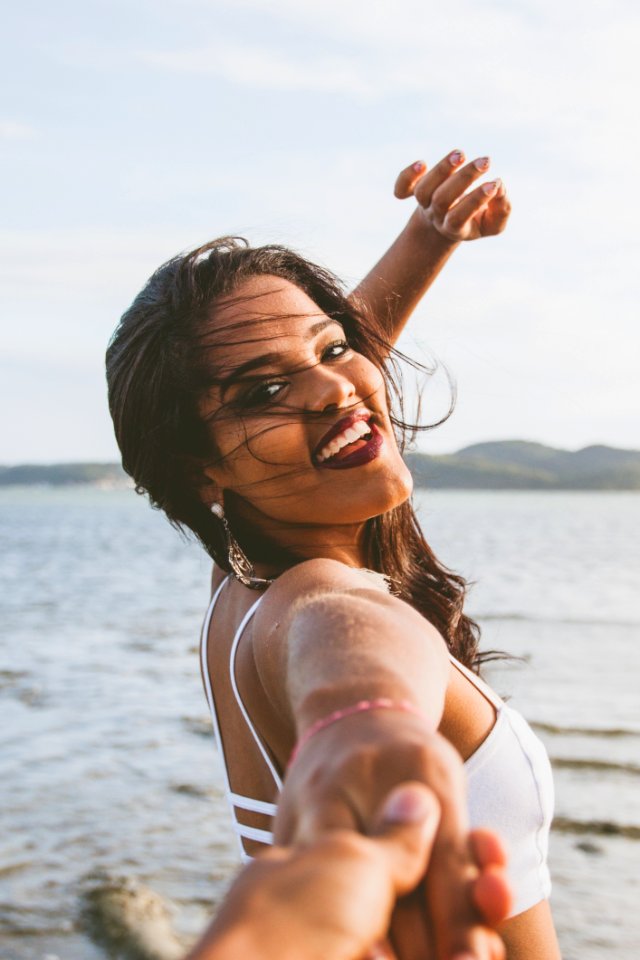 Woman Wearing White Bralet Near Seashore During Daytime