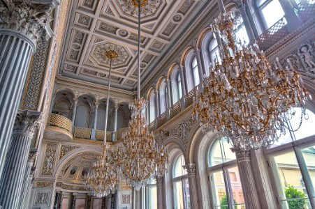 White Cathedral Hanging With Three Brown Uplight Chandelier photo