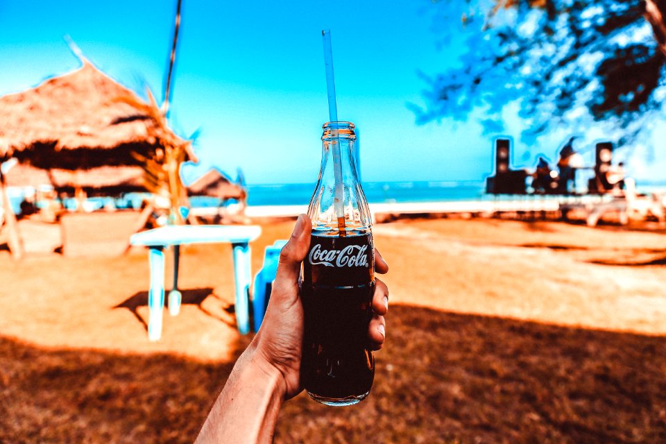 Person Holding Coca-cola Glass Bottle