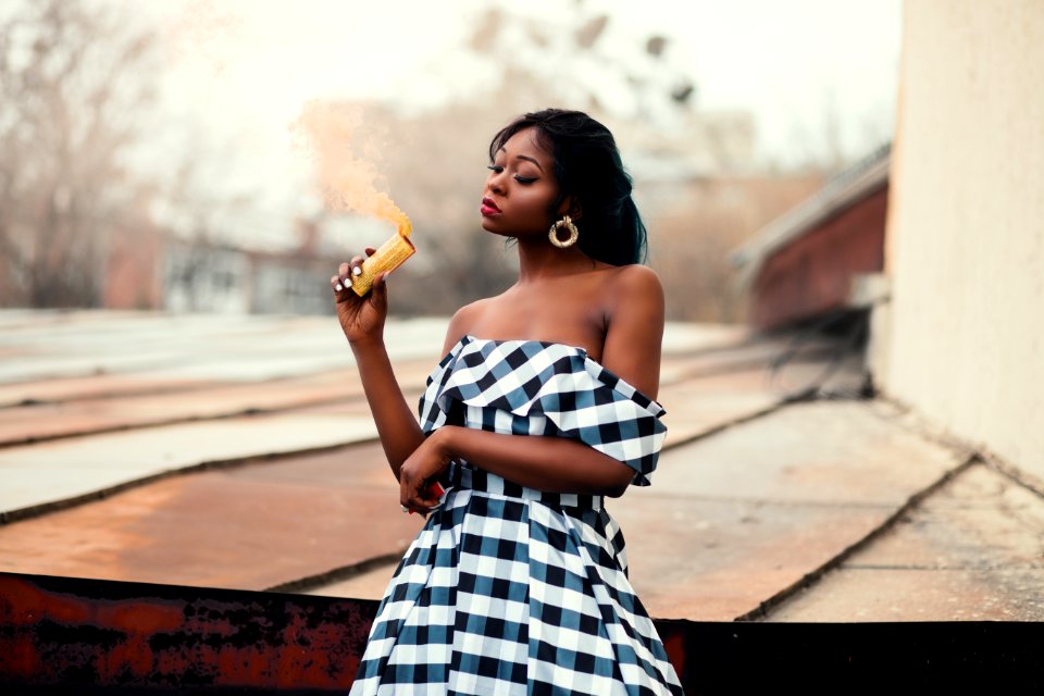 Woman In Black And White Off-shoulder Dress Standing Near On Brown Wood Panel