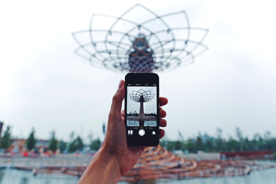 Person Taking Photo Of Tower