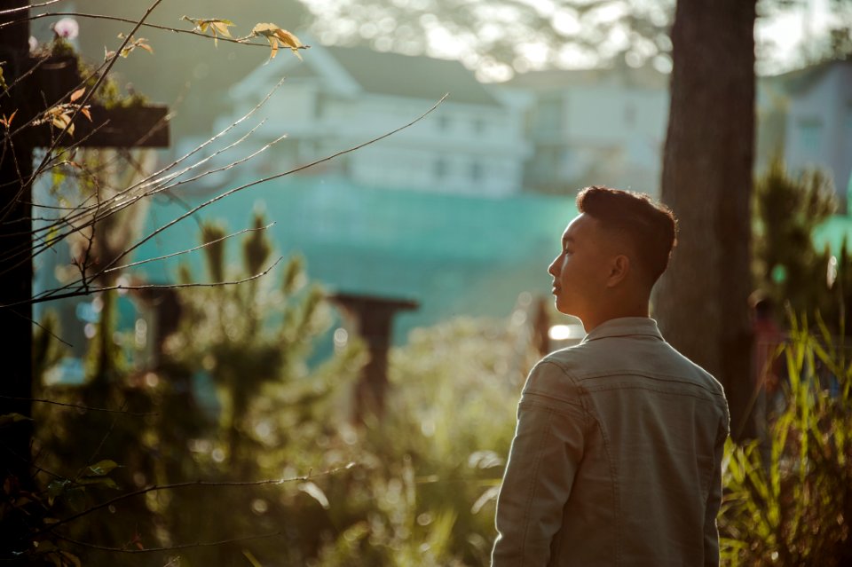 Man Wearing Gray Dress Shirt Standing Near Green Leaf Plant photo