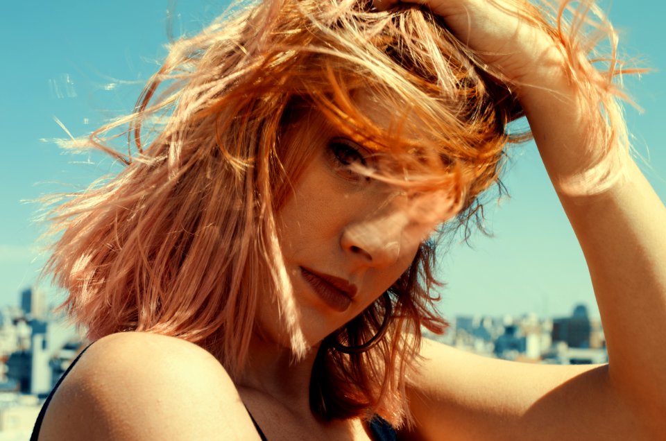 Close-up Photography Of A Woman Touching Her Hair photo