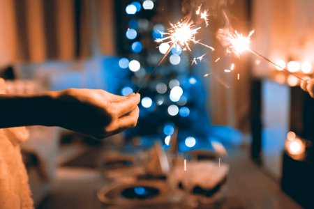 Close Up Photograph Of Two Person Holding Sparklers photo