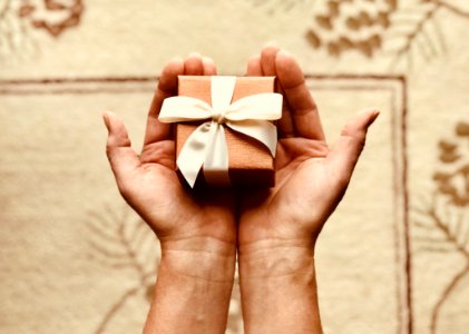 Persons Holds Brown Gift Box photo