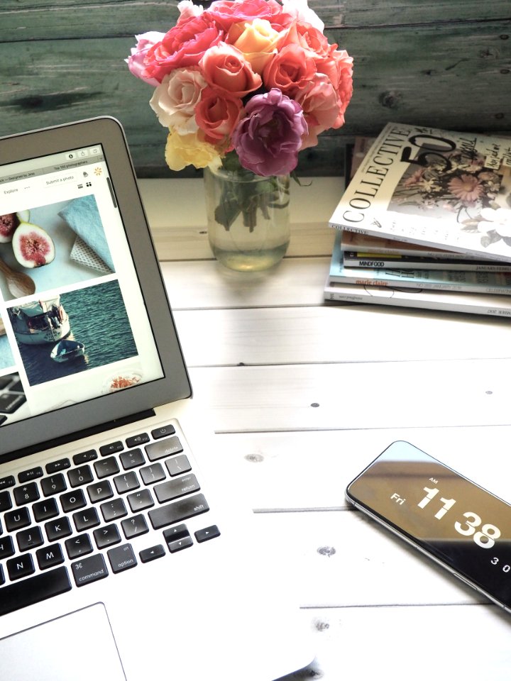 Macbook Air Flower Bouquet And Magazines On White Table
