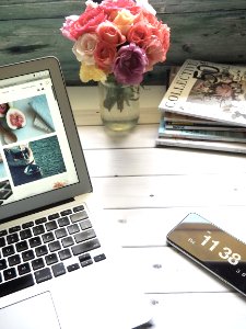 Macbook Air Flower Bouquet And Magazines On White Table