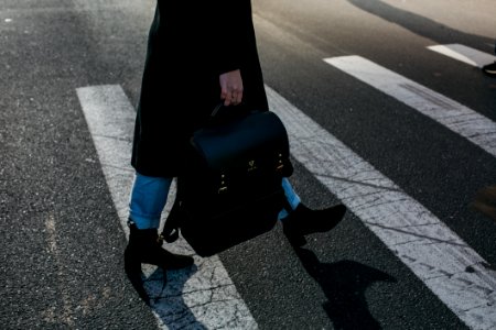 Person Carrying Bag Walking On Pedestrian Lane photo