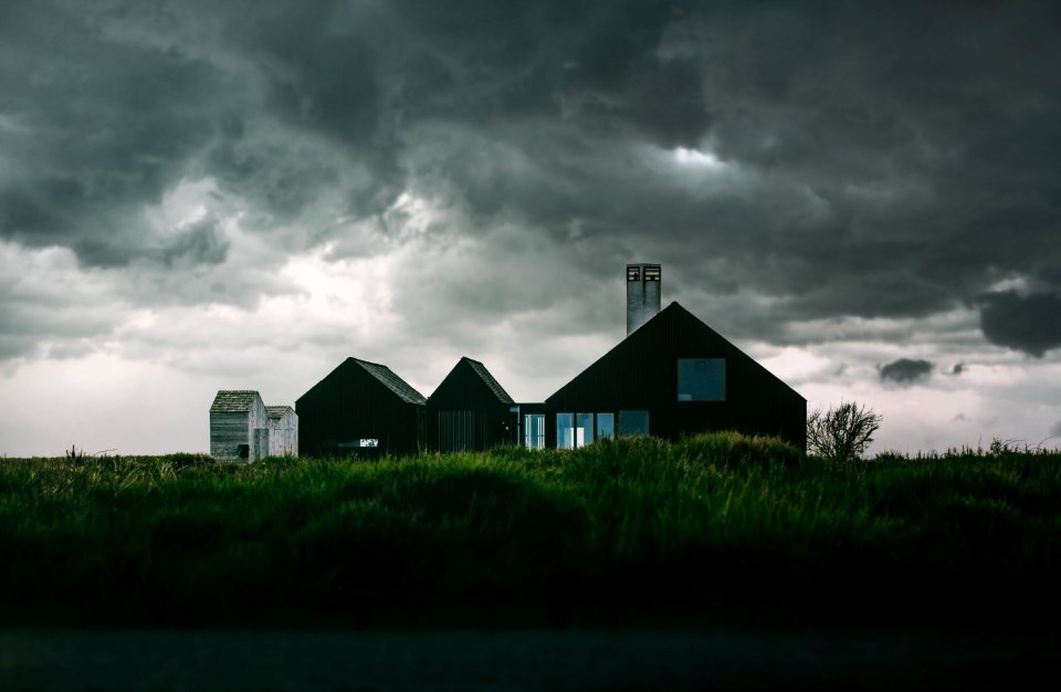 Black And White House Under Thick Clouds