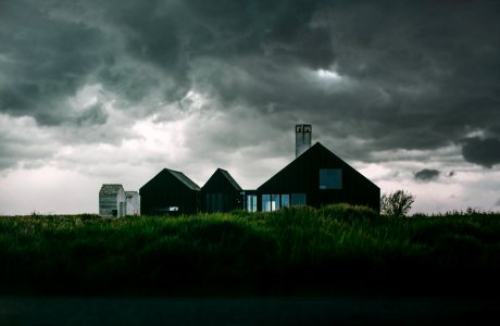 Black And White House Under Thick Clouds photo