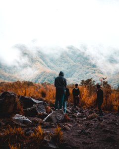 Group Of People Near Foggy Mountain