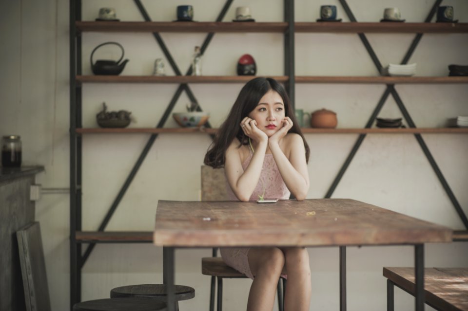 Photography Of A Woman Sitting On The Chair Listening To Music