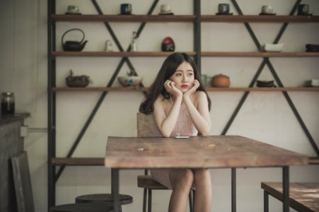 Photography Of A Woman Sitting On The Chair Listening To Music