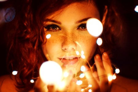 Photography Of A Woman Holding Lights photo