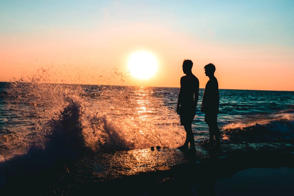 Two Men Standing On Seashore