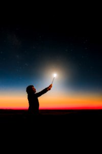Person Holding Roman Candle At Night