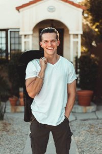 Man In White V-neck T-shirt And Black Pants photo