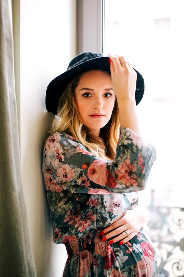 Woman In Multicolored Floral Long-sleeved Dress And Black Hat