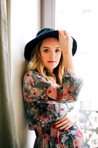 Woman In Multicolored Floral Long-sleeved Dress And Black Hat photo