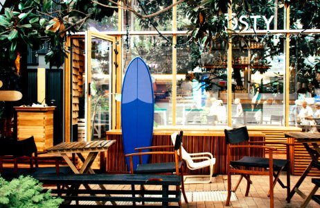 Blue Surfboard Leaning On Desk photo