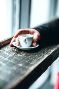 Person Holding White Teacup photo