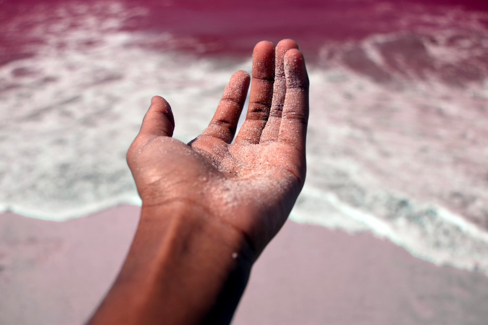 Persons Left Hand Covered With Sand