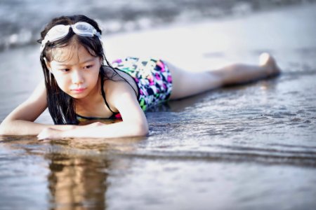 Selective Color Photography Of Girl Lying On Beach photo