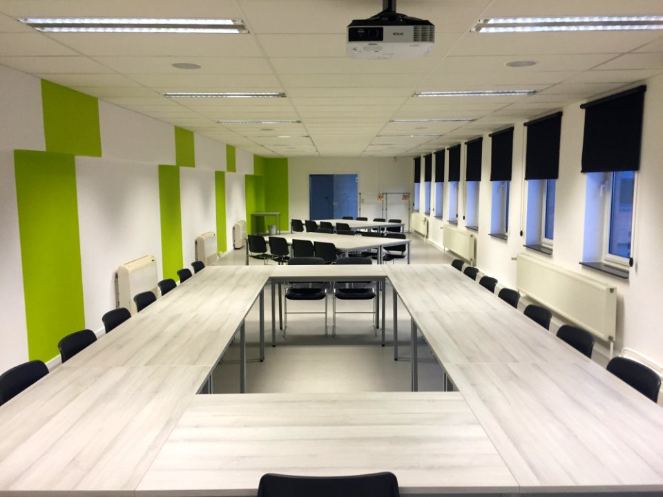 White Wooden Table And Black Chairs Inside White Green Painted Room