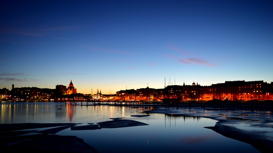 View Of City At Waterfront At Night photo