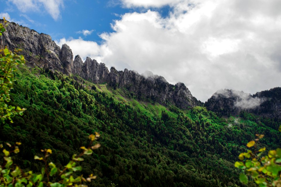 Green Trees And Mountains Under White And Blue Clouds