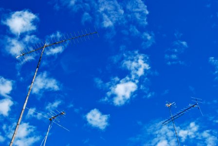 Three Antenna Are Standing Over Sky photo