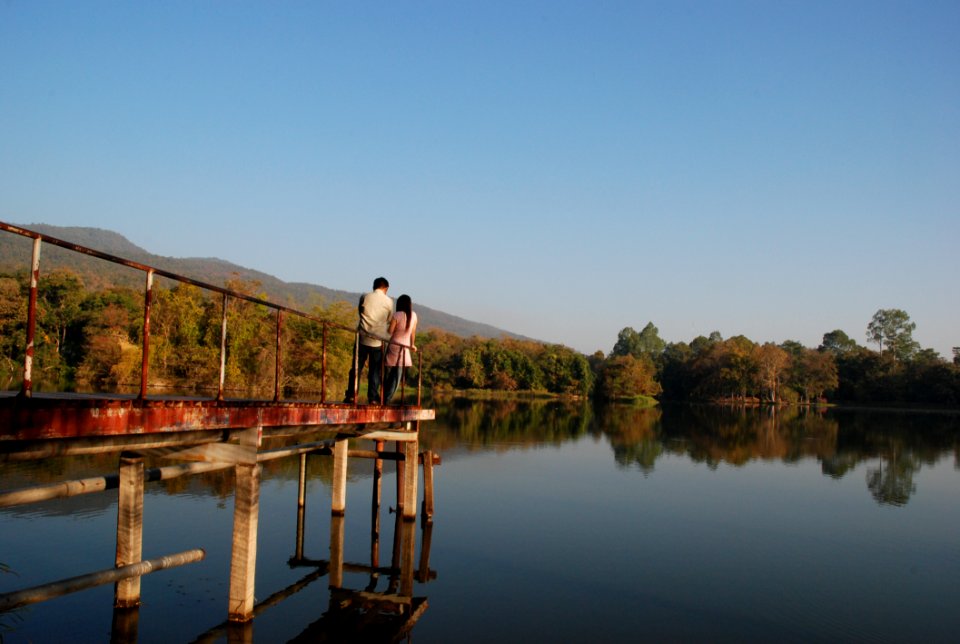 Man And Woman Stand On Bridge