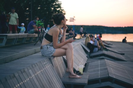 A Girl Sitting At The Lake In The City photo