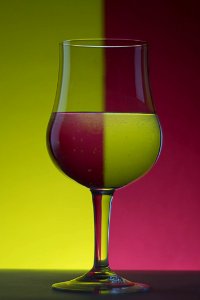 Close-up Of Beer Glass Against Colored Background photo