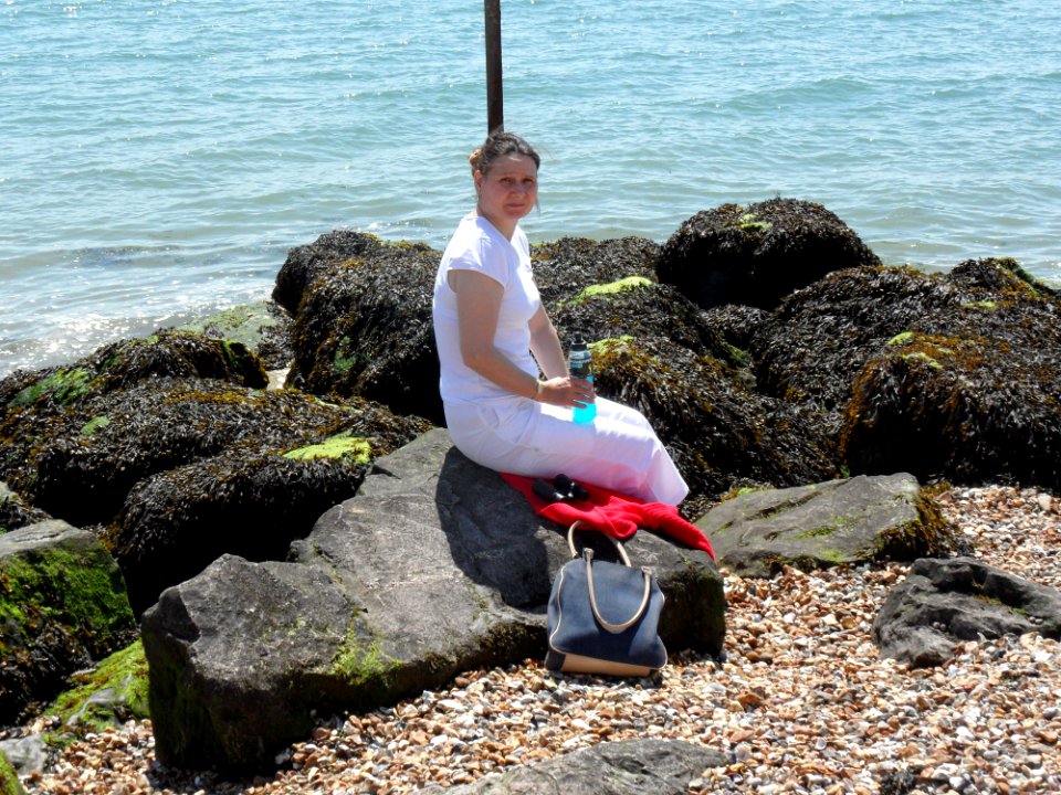 Woman Sitting On The Rocks photo