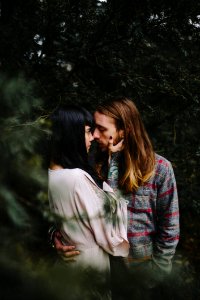 Couple Kissing In Forest photo