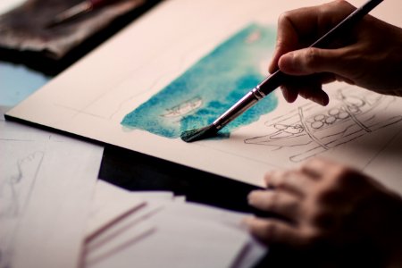 Person Painting In White Cardboard