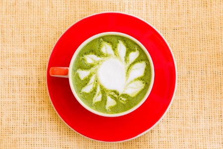 Matcha Drink On Red Ceramic Bowl photo