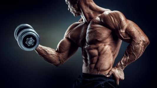 Bodybuilder Doing Dumbbell Curl photo