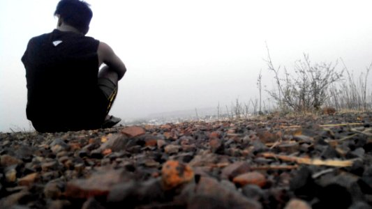 Man Sitting On Gravel photo